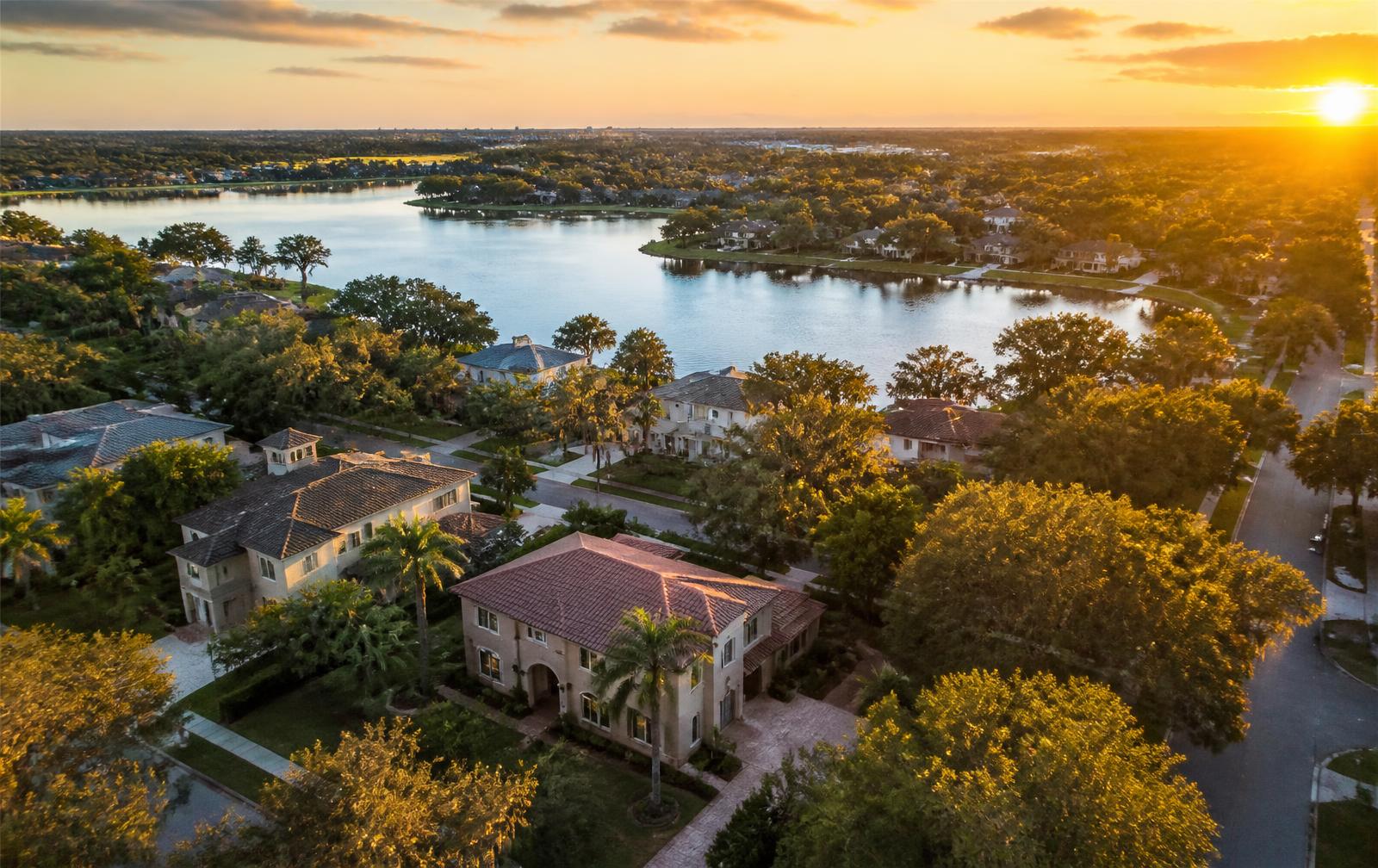 Aerial view of a Lakeland, Florida lakefront neighborhood at sunset